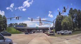 Road crews working on traffic signals at an intersection.