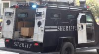 Sheriff's armored vehicle with its rear door open.