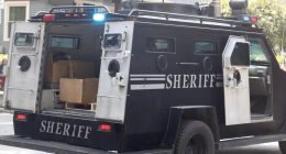 Sheriff's armored vehicle with its rear door open.
