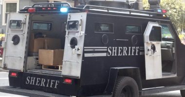 Sheriff's armored vehicle with its rear door open.