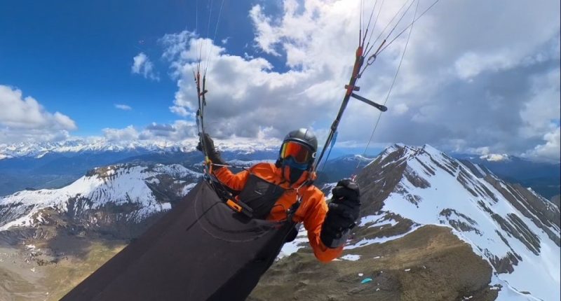 A paraglider in the French Alps during a storm.