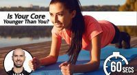 Girl does a plank exercise by the lake on nature
