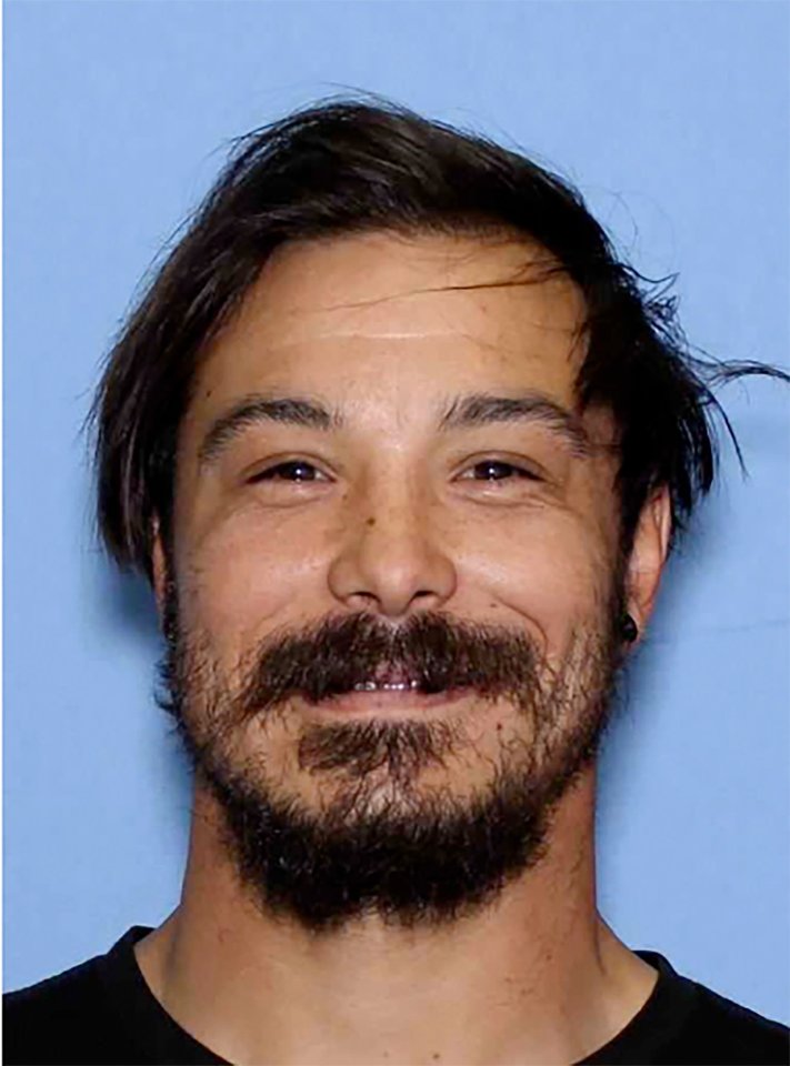 Mugshot of Travis Caleb Decker, wanted for murder.