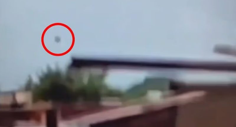 Video still showing an object falling from the sky.