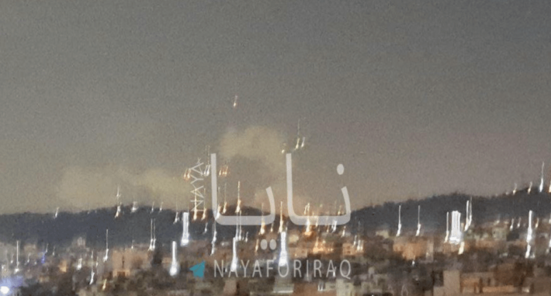 Nighttime view of a city with fireworks.