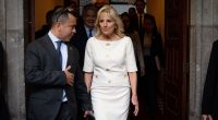 First Lady Jill Biden speaking with an advisor before a speech.