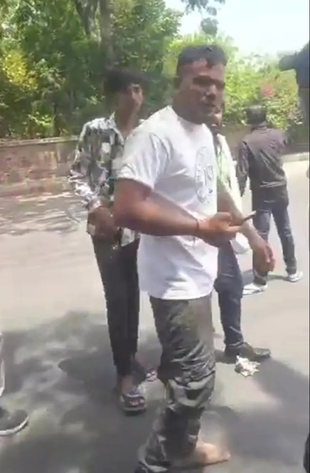 Video still of a man walking away from a crash.