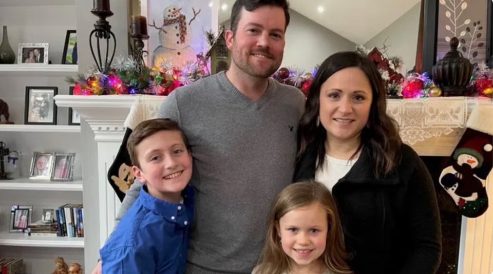 Family portrait in front of a fireplace.