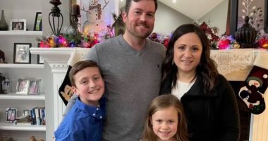 Family portrait in front of a fireplace.