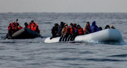 An image collage containing 1 images, Image 1 shows Migrants in inflatable boats at sea