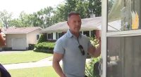 Homeowner stands outside his home, which was recently occupied by squatters.