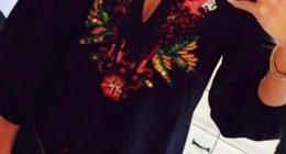 Selfie of a woman wearing an embroidered black dress.