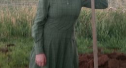 Photo of Rachelle Fischer, a missing teenager, standing in a field with a shovel.