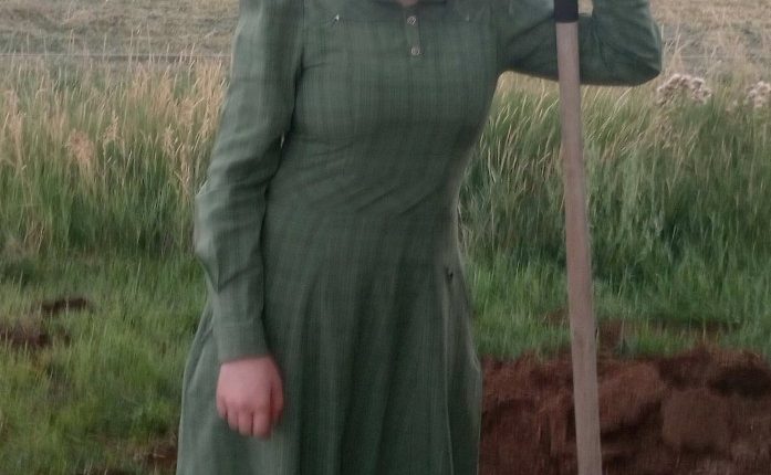 Photo of Rachelle Fischer, a missing teenager, standing in a field with a shovel.