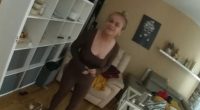 Woman in brown outfit in her living room.