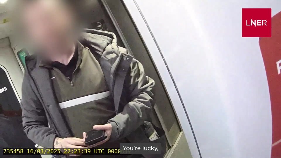 Video still of a passenger abusing a train ticket inspector.
