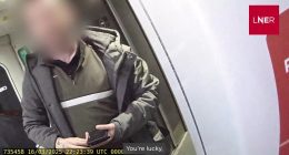 Video still of a passenger abusing a train ticket inspector.