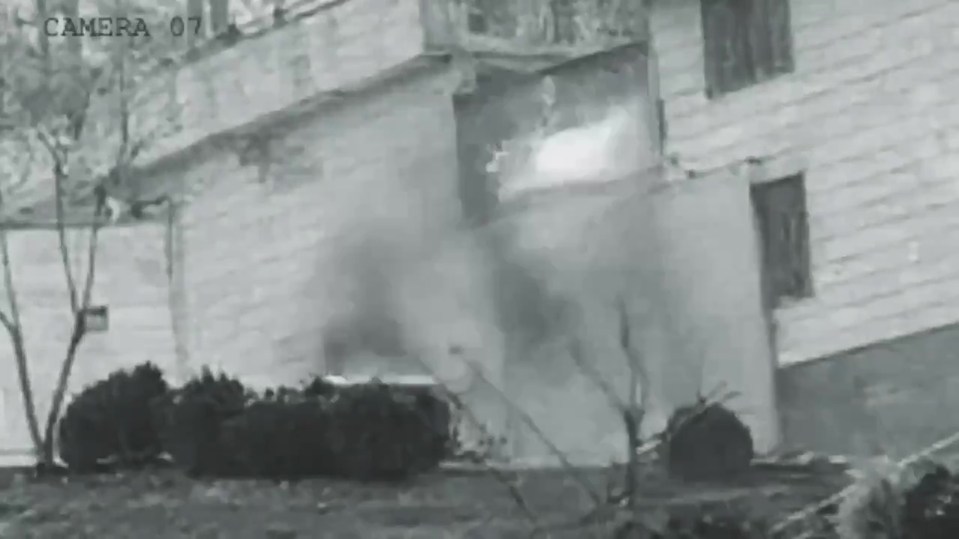 Grainy security camera footage of an explosion at Evin prison in Iran.