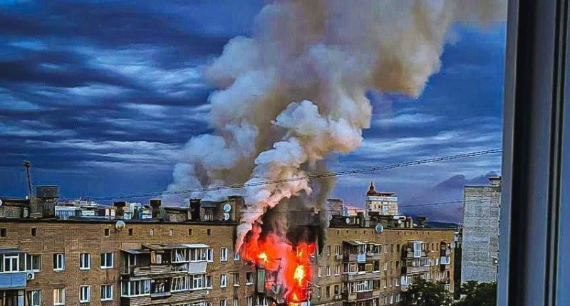 Smoke billowing from a burning building in Kharkiv, Ukraine, after an airstrike.