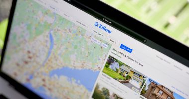 Laptop displaying Zillow real estate listings.