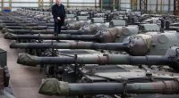 Freddy Versluys, CEO of OIP Land Systems, standing on Leopard 1 tanks.
