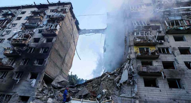 Rescue worker searching for survivors in rubble of bombed building.