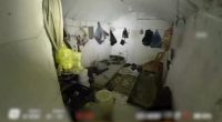 Drone footage of a cluttered underground room.