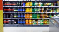 Supermarket shelves stocked with various beverages for sale.
