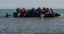 Migrants in a small inflatable boat crossing the English Channel.