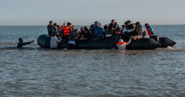 Migrants in a small inflatable boat crossing the English Channel.