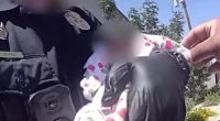 Police officer rescuing an emaciated newborn baby.