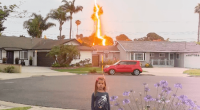 Lightning striking a palm tree near a house with a young girl standing nearby.