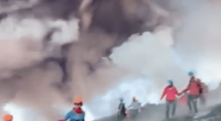 Tourists fleeing Mount Etna's eruption.