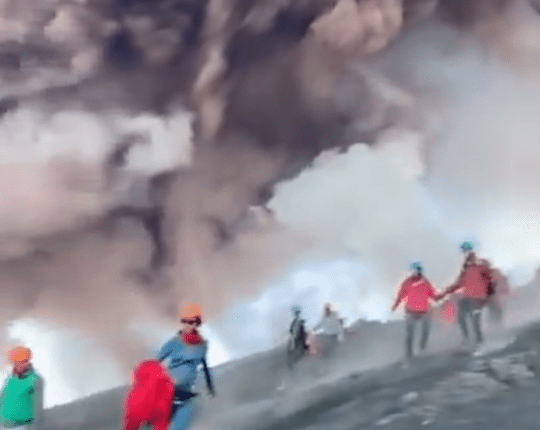 Tourists fleeing Mount Etna's eruption.