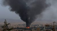 Smoke rising from a burning building in Tehran, following an Israeli strike.