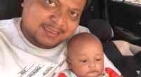 Photo of a father and his baby son in a car.