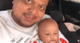 Photo of a father and his baby son in a car.