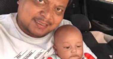 Photo of a father and his baby son in a car.