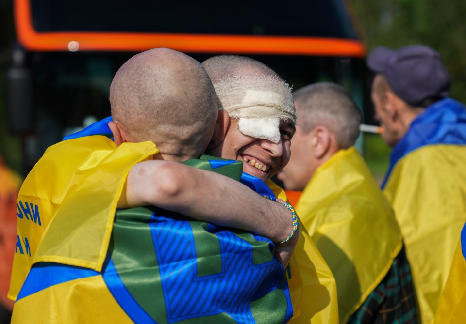 Ukrainian prisoners of war embracing after a prisoner exchange.