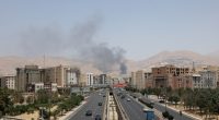 Smoke rises over a Tehran highway.