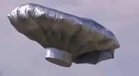 Silver, metallic balloon in the sky.