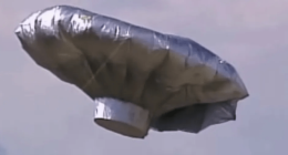 Silver, metallic balloon in the sky.