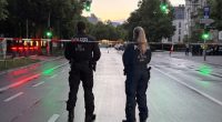 Two police officers guarding a crime scene.