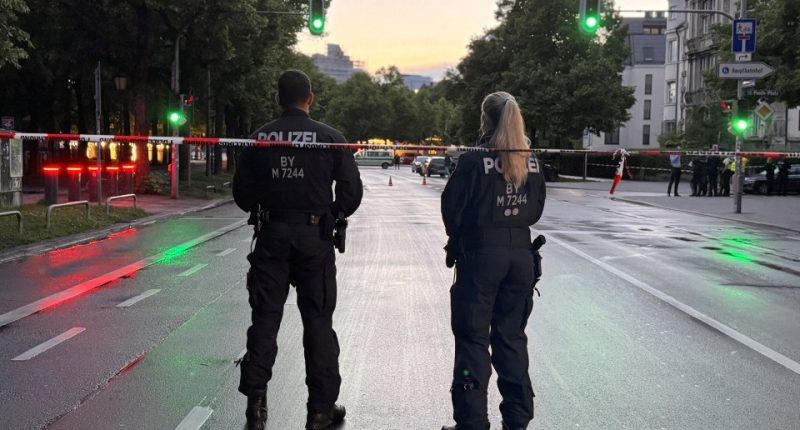 Two police officers guarding a crime scene.