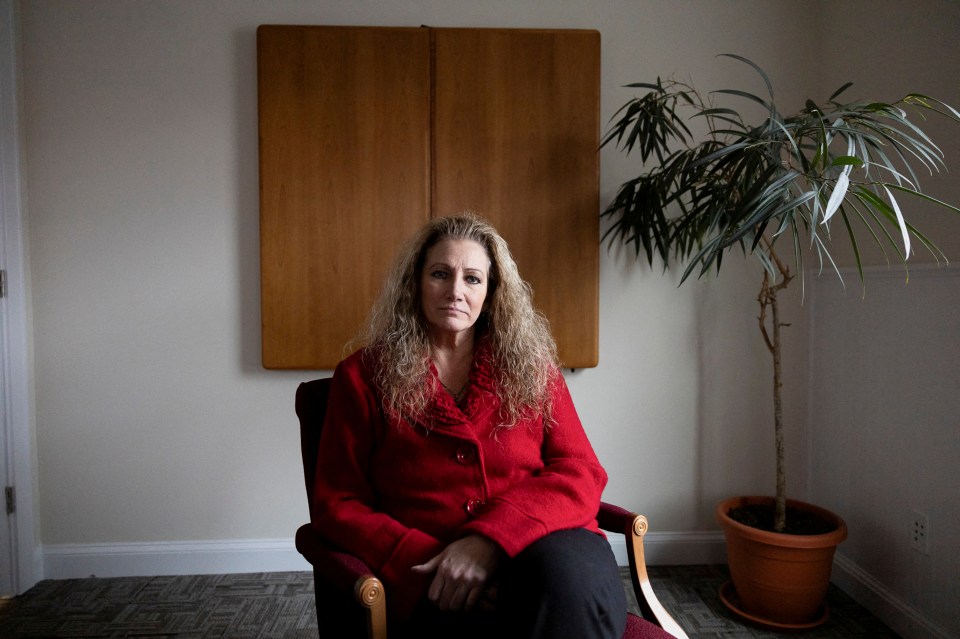 Portrait of Marlean Ames sitting in a chair in a law office.