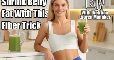 Happy woman with glass of fresh celery juice in kitchen. Women Over 50 Are