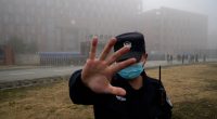 Security guard blocking access to the Wuhan Institute of Virology.