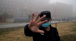 Security guard blocking access to the Wuhan Institute of Virology.