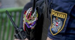 A police officer is decorated with Taylor Swift bracelets while guarding the city centre in Vienna on August 8, 2024.