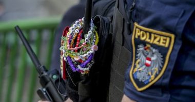 A police officer is decorated with Taylor Swift bracelets while guarding the city centre in Vienna on August 8, 2024.